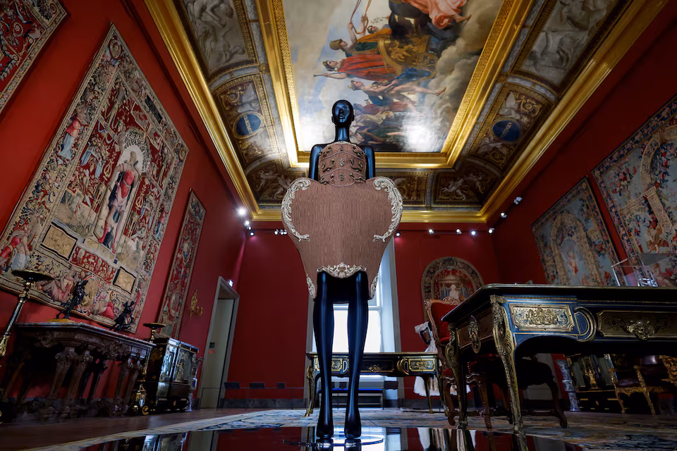 A dress designed by Jeremy Scott for fashion house Moschino from the F/W 2022-2023 collection is displayed at the exhibition "Louvre Couture. Art and fashion: statement pieces" at the Louvre Museum in Paris, France, January 23, 2025. Image source: REUTERS/Gonzalo Fuentes